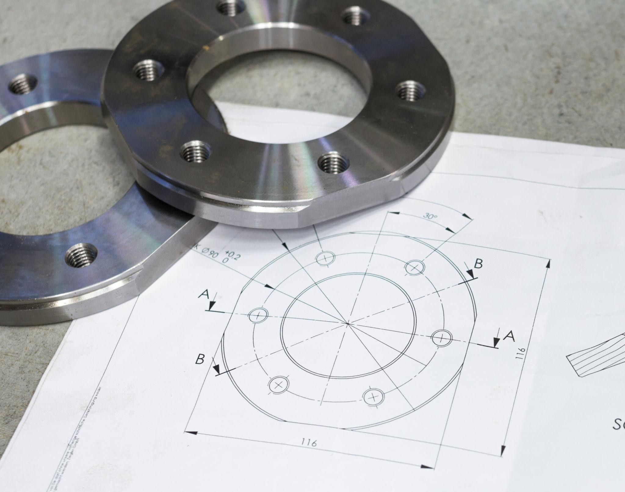 Engineering drawing alongside a machined part