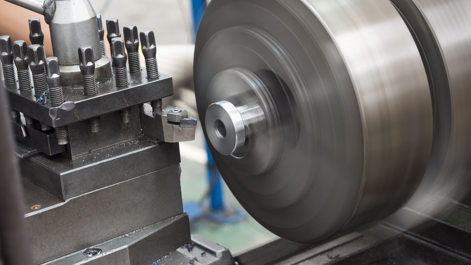 Operator running a manual engine lathe