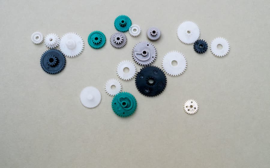 Plastic gears in teal, white, and grey